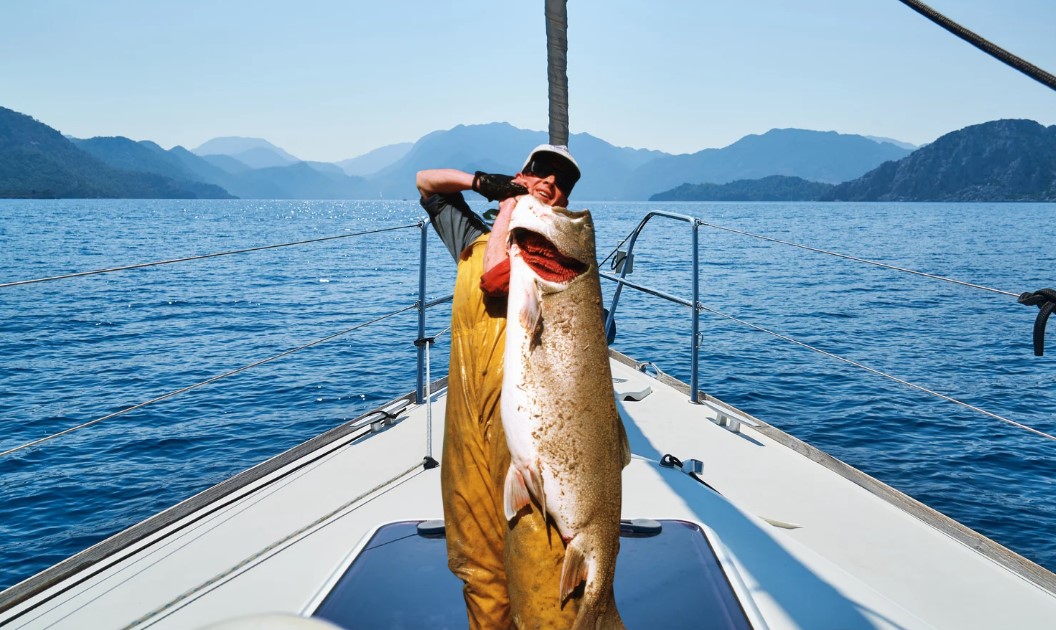 Lloyd Bull holding the biggest trout ever caught