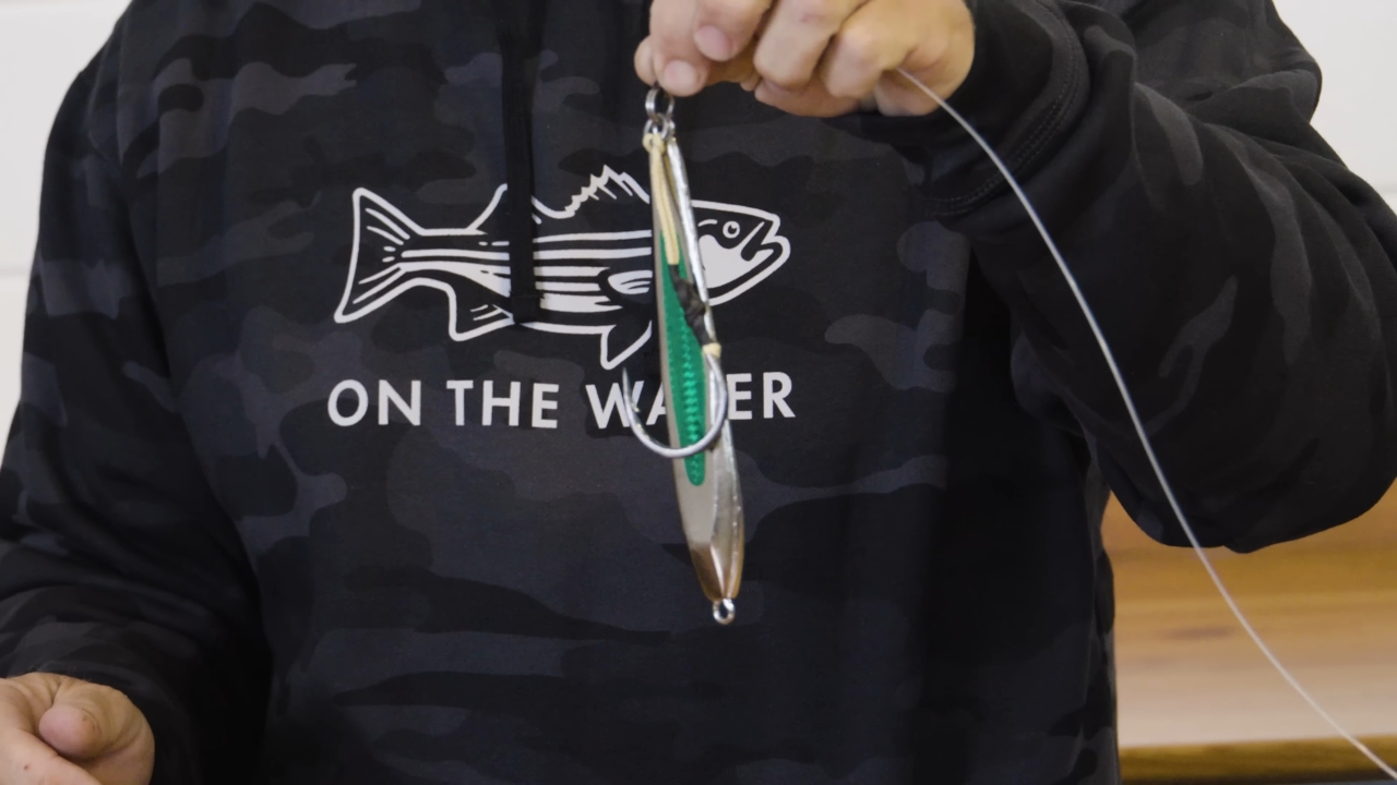 An angler holds a metal jig rig used for bluefin tuna fishing